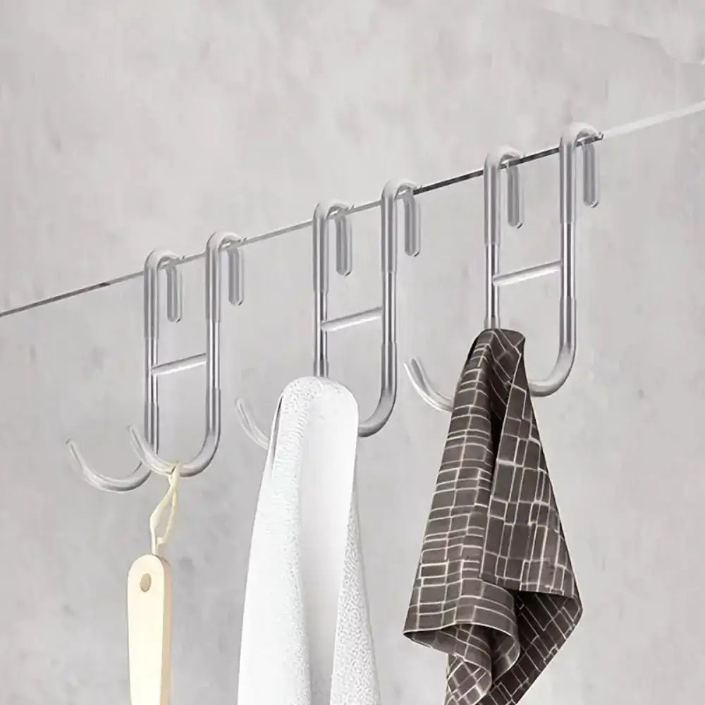 Rust Resistant Multifunctional Shower Door Hook displayed on a sleek bathroom wall, ideal for towels and loofahs.