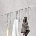 Rust Resistant Multifunctional Shower Door Hook displayed on a sleek bathroom wall, ideal for towels and loofahs.